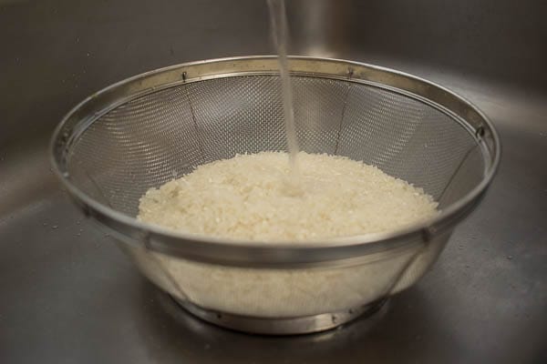 Measure out 2 cups of rice, rinse it until the water runs clean, let it drain, then add 2 + 1/3 cup water.