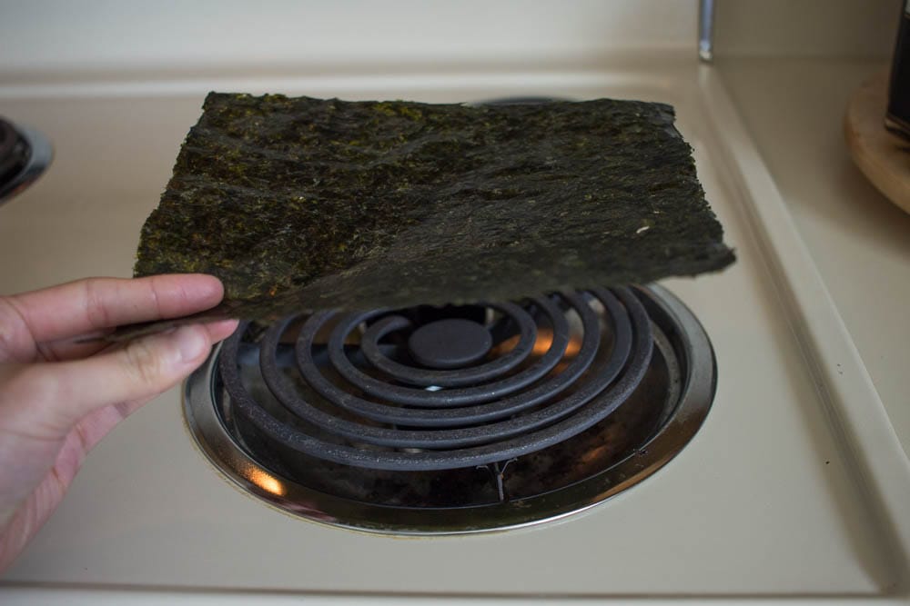 Toast the seaweed over a hot surface for a few seconds.